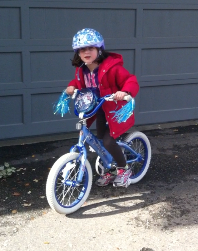 Emily Judith Mitnick is starting to ride the bike in front of the house.