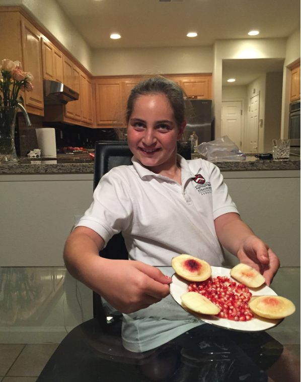 Emily Judith Mitnick arranged a peach and pomegranate seeds into a masterpiece