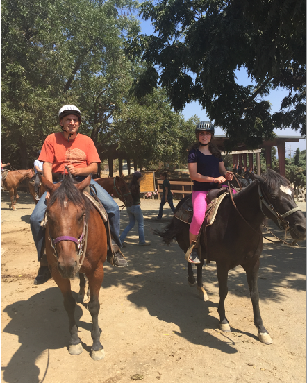 Emily Judith Mitnick riding a horse at her favorite stables.