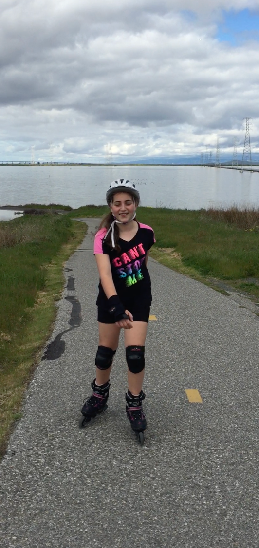 Emily Mitnick rollerblades on a fun down and up trail with sharp curve.