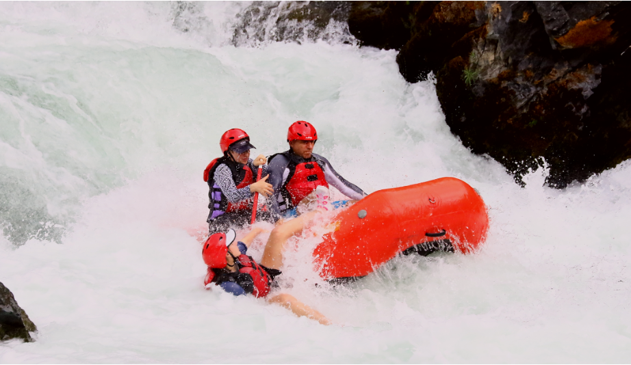 Emily Mitnick is falling out of the boat on a tough rapid.