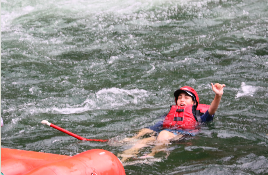 Emily Judith Mitnick signals that she is OK after falling out of the boat.